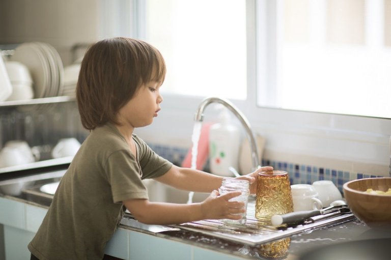 a young boy learns responsibility through household chores