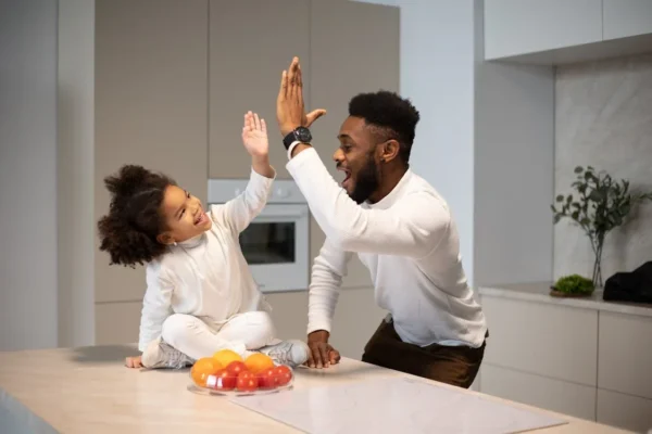 Dad praising daughter for helping clean the house