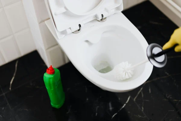 Woman cleaning the bathroom with the right cleaning products
