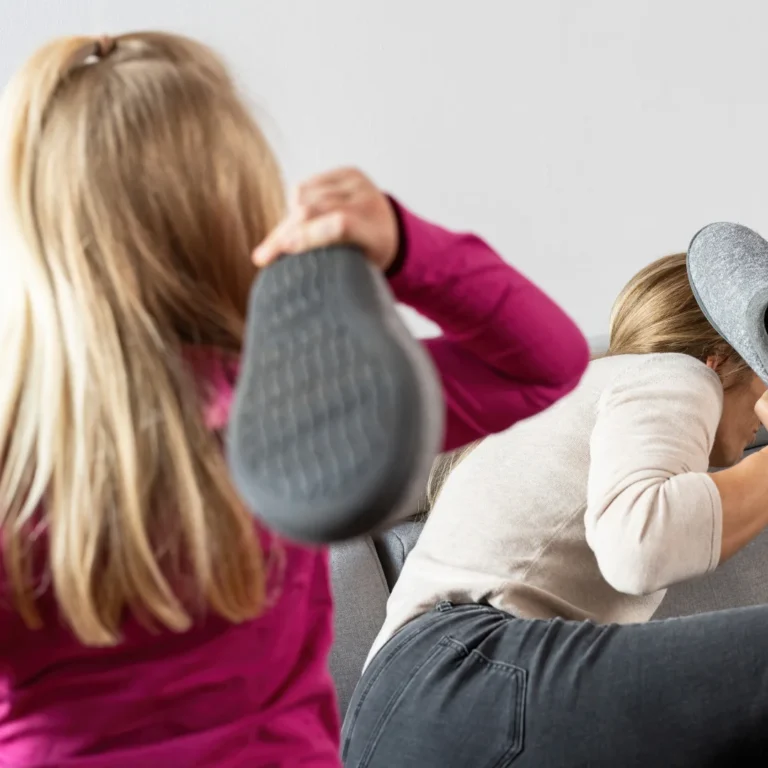 angry girl hitting her mom with a slipper