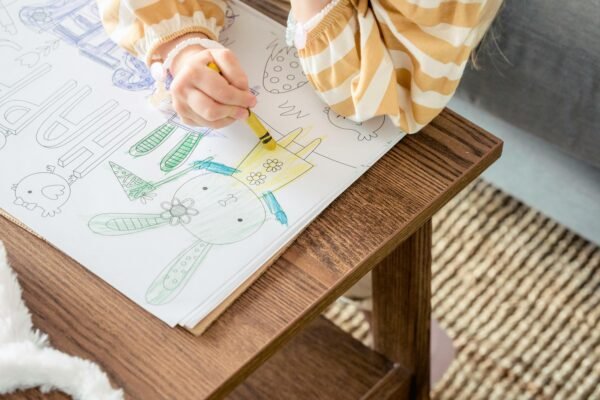 A child coloring on a sheet of paper