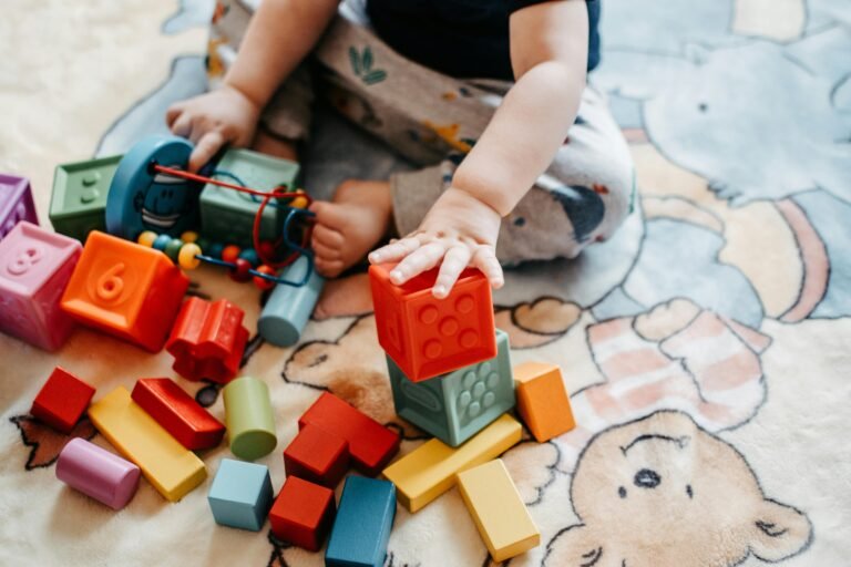 1-year-old baby enjoying pile of toys